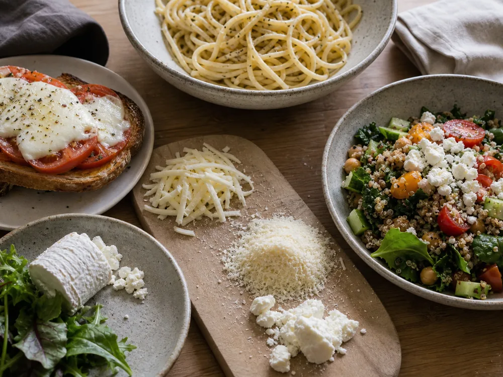 Small portions of part-skim mozzarella, hard grating cheese, goat cheese, and feta beside meals they fit - Is cheese healthy | KnowTheCheese