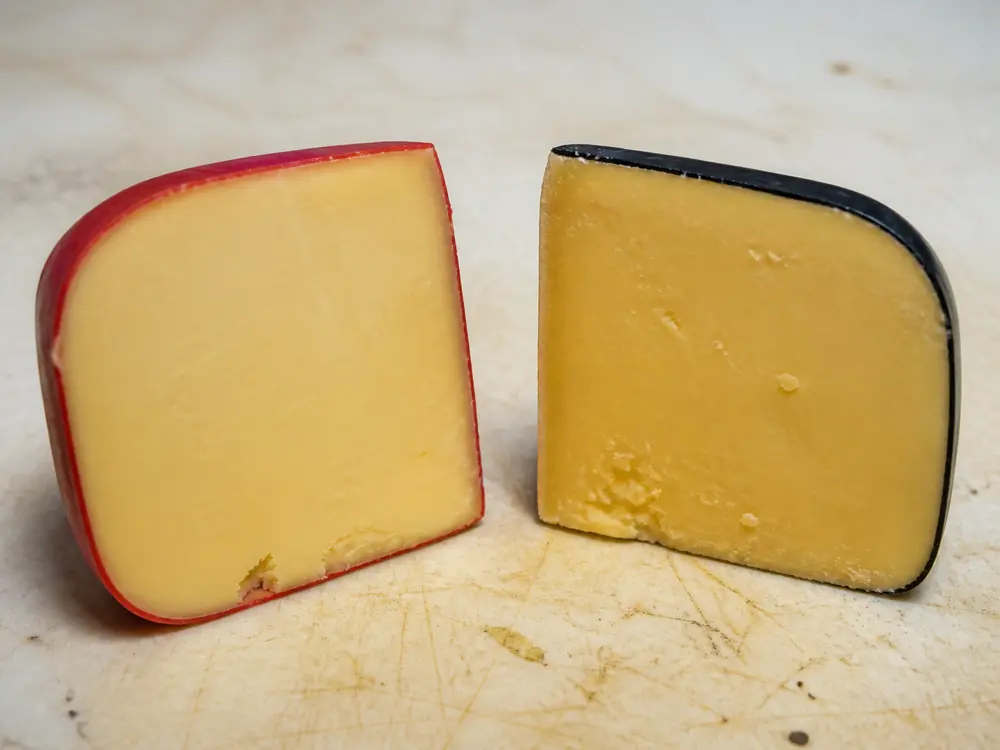 Red-wax and black-wax hoop cheese cut faces - Hoop cheese | KnowTheCheese