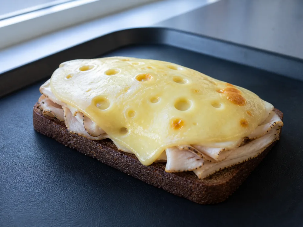 Jarlsberg melted over an open-faced rye and turkey sandwich - Jarlsberg | KnowTheCheese