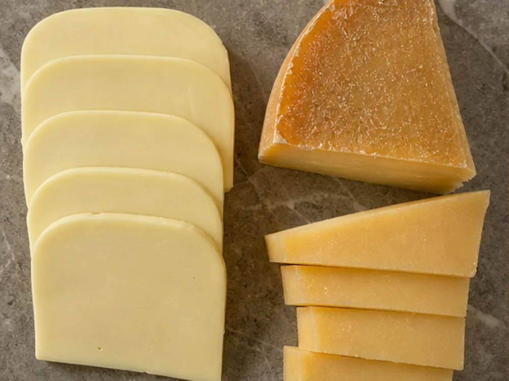 Fresh pale Kaşar slices beside a firmer aged Kaşar wedge - Kashar cheese | KnowTheCheese