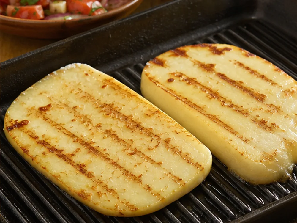 Thick Kashkaval slices browning on a ridged grill pan - Kashkaval cheese | KnowTheCheese
