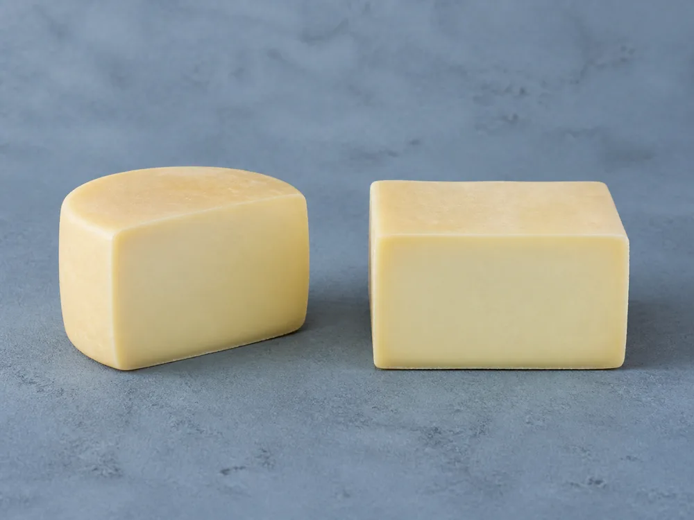 Cylindrical and block Kasseri forms with compact yellowish-white paste - Kasseri | KnowTheCheese
