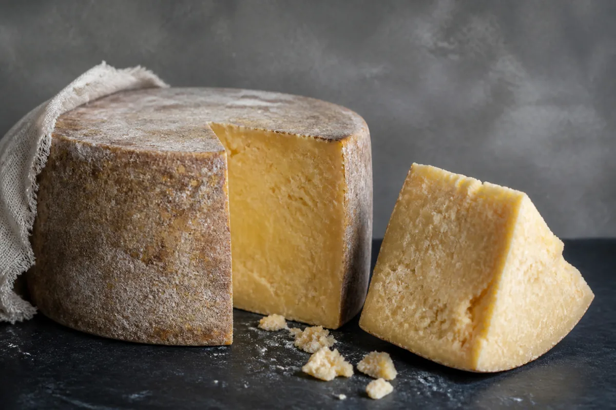Clothbound farmhouse Cheddar wedge with a rough natural rind - Keen's Cheddar | KnowTheCheese