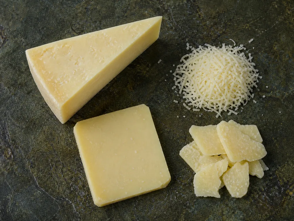 Kefalotyri wedge shown as a frying slice, fine grate, and table shards - Kefalotyri | KnowTheCheese
