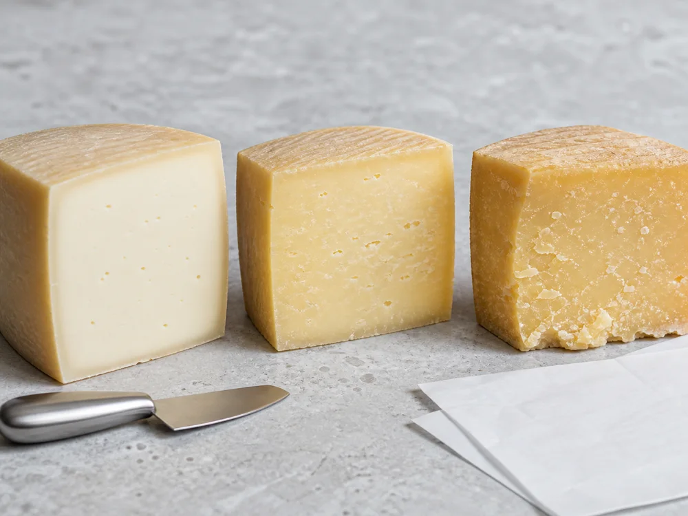 Three Kefalotyri cut faces progressing from smooth and pale to dry and granular - Kefalotyri | KnowTheCheese
