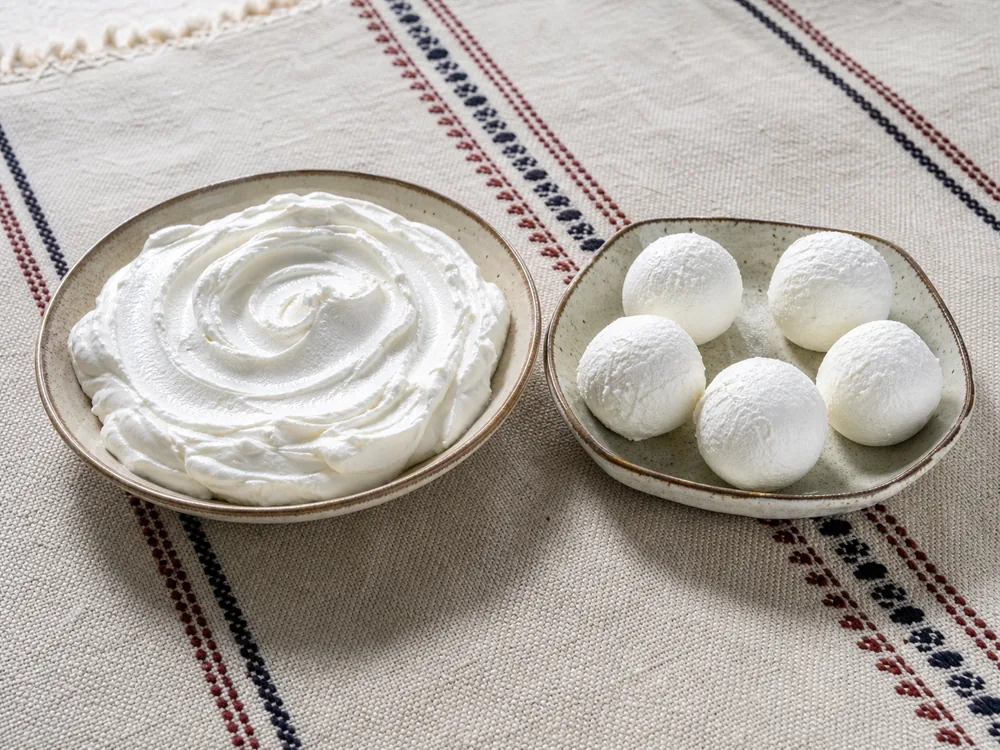 Spreadable labneh beside firm rolled labneh balls - Labneh | KnowTheCheese