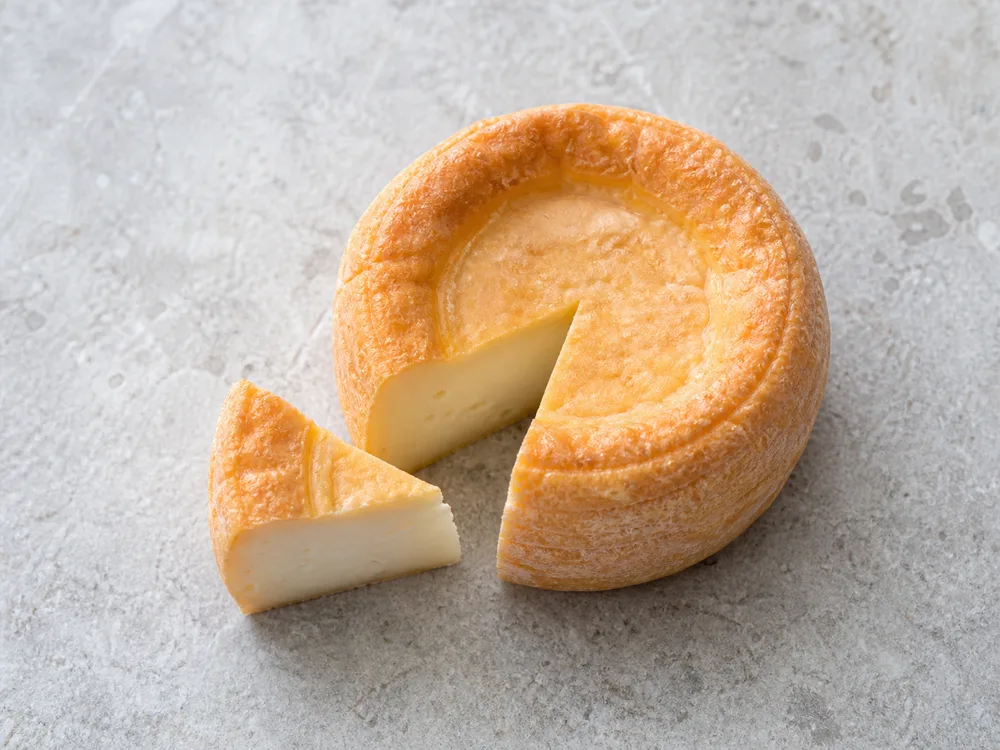 Langres cut from its center toward the rind for even portions - Langres | KnowTheCheese