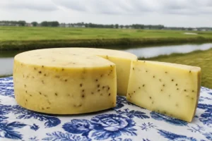Flat Leyden cheese wheel and cumin-speckled wedge - Leyden | KnowTheCheese