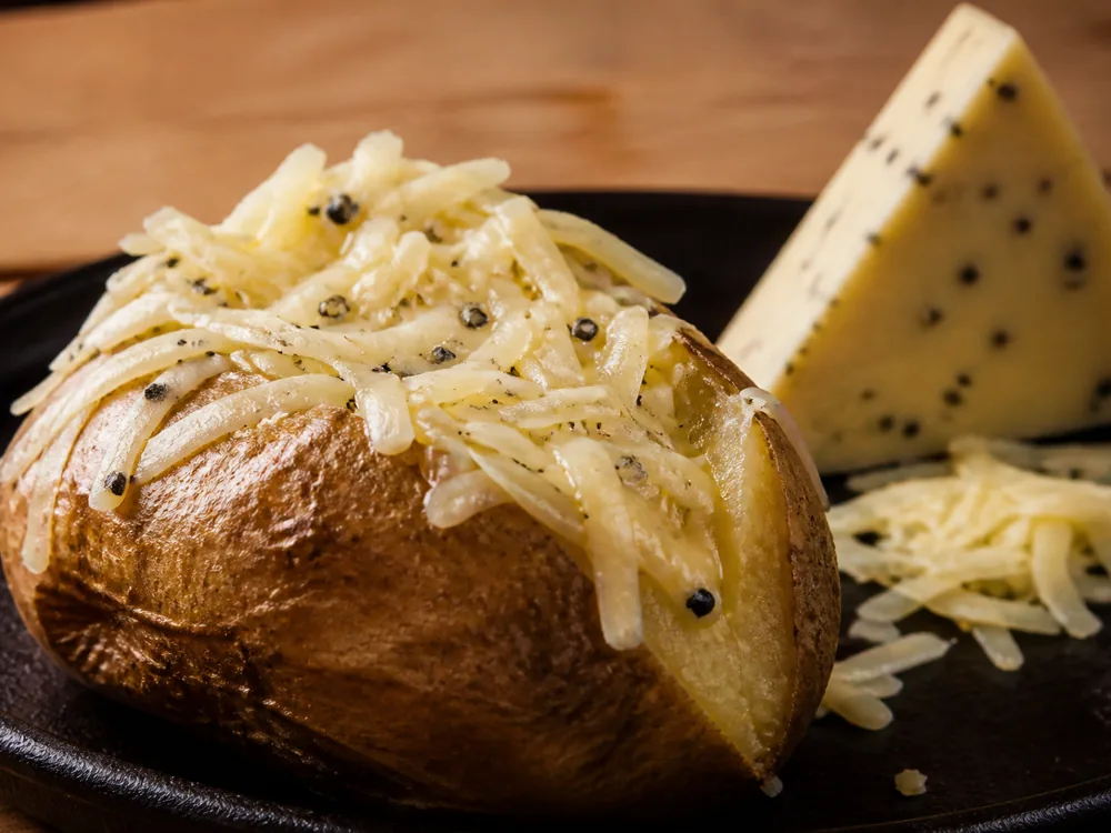 Grated Marco Polo cheese melting over a baked potato - Marco Polo | KnowTheCheese