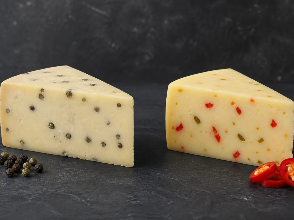 Marco Polo peppercorn cheese beside Pepper Jack with chile pieces - Marco Polo | KnowTheCheese