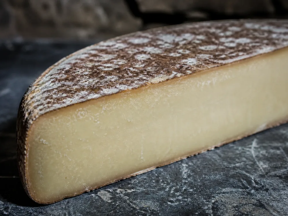 Natural brown rind and firm pale paste of cave-aged Marisa - Marisa | KnowTheCheese