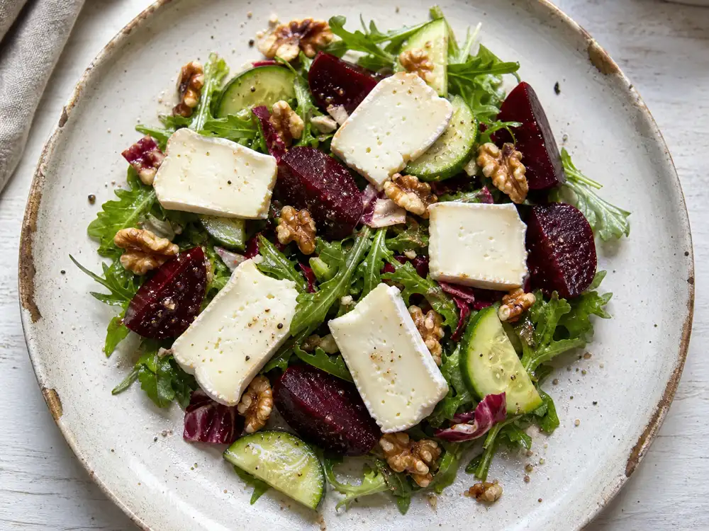 Mild goat cheese slices on beet cucumber and walnut salad - Mild Goat's Cheese | KnowTheCheese