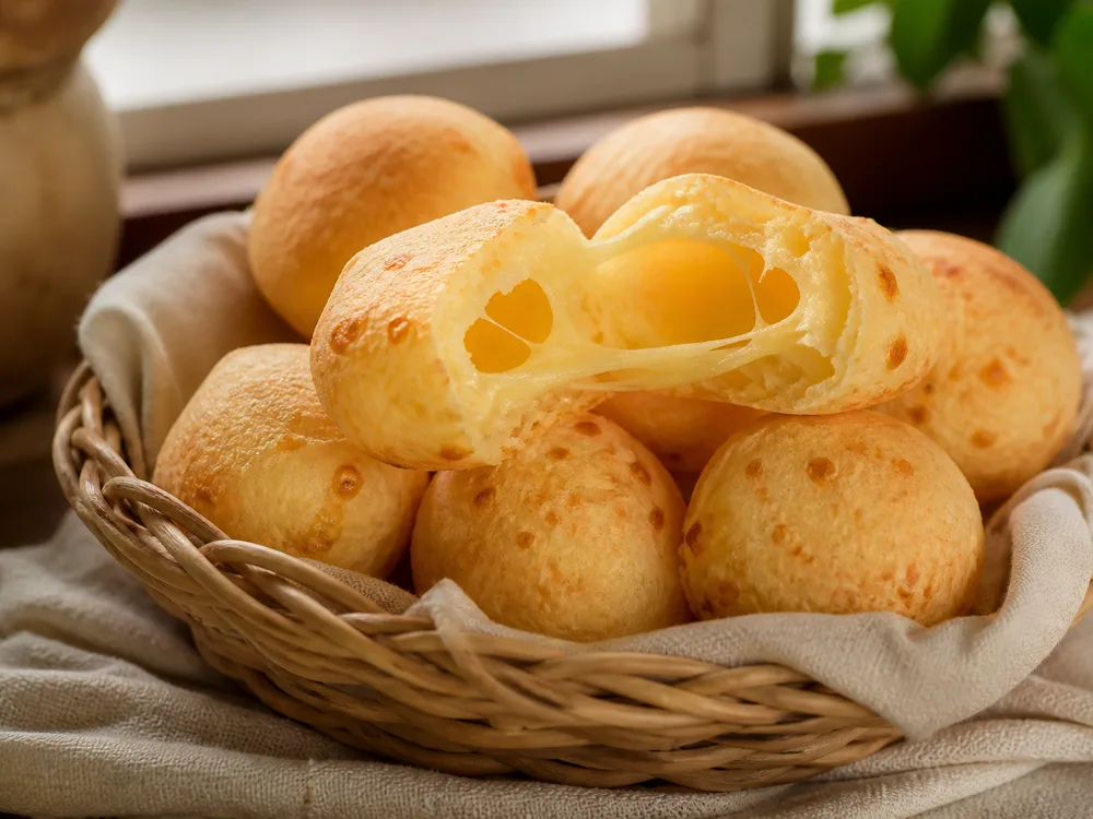Small round cheese breads with one torn open to show a hollow stretchy interior - Minas cheese | KnowTheCheese