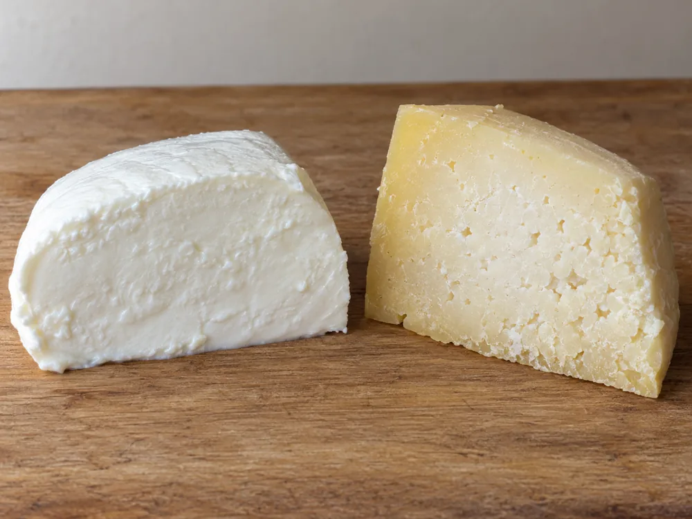 A soft white cheese beside a firmer, yellowish aged cheese with a paler core - Minas cheese | KnowTheCheese