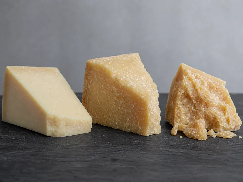 Three Parmesan samples showing increasing dryness and crystals with age - Parmesan cheese | KnowTheCheese
