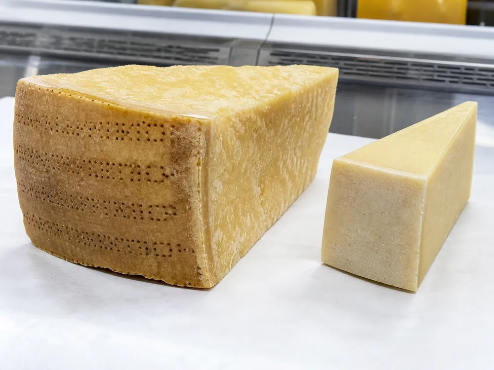 Dotted natural rind on aged Parmesan beside a plain hard-cheese rind - Parmesan cheese | KnowTheCheese