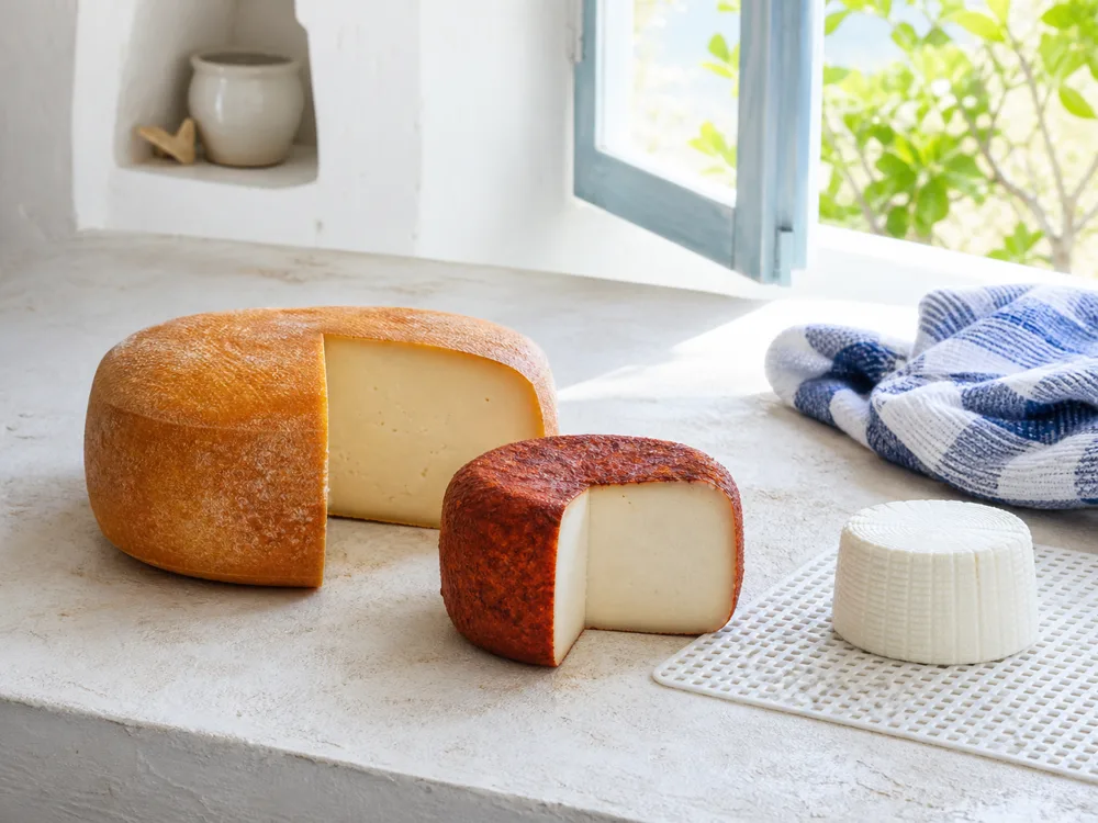 Rounded-square Mahon-style wheel, paprika-coated Majorero-style cheese, and a fresh Catalan-style cheese - Spanish cheese regions | KnowTheCheese