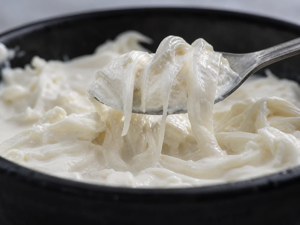 Torn mozzarella ribbons in creamy Stracciatella - Stracciatella | KnowTheCheese
