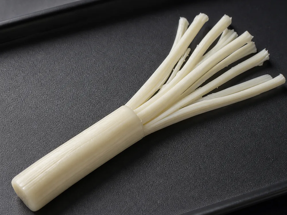 Mozzarella string cheese peeled into long parallel fibers - String Cheese | KnowTheCheese