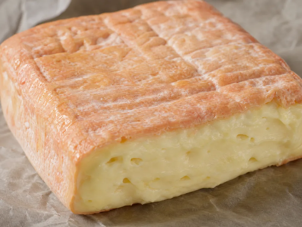 Cut Taleggio square with washed rind and creamy paste - Taleggio Cheese | KnowTheCheese