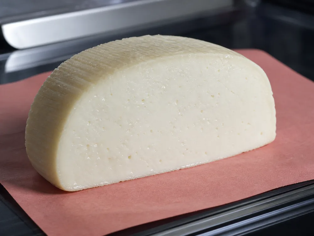 Fresh Teleme deli portion with a moist fine cut face and clean flexible edge - Teleme | KnowTheCheese
