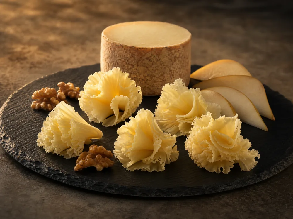 Tete-de-Moine rosettes served with pear and walnuts - Tete-de-Moine | KnowTheCheese
