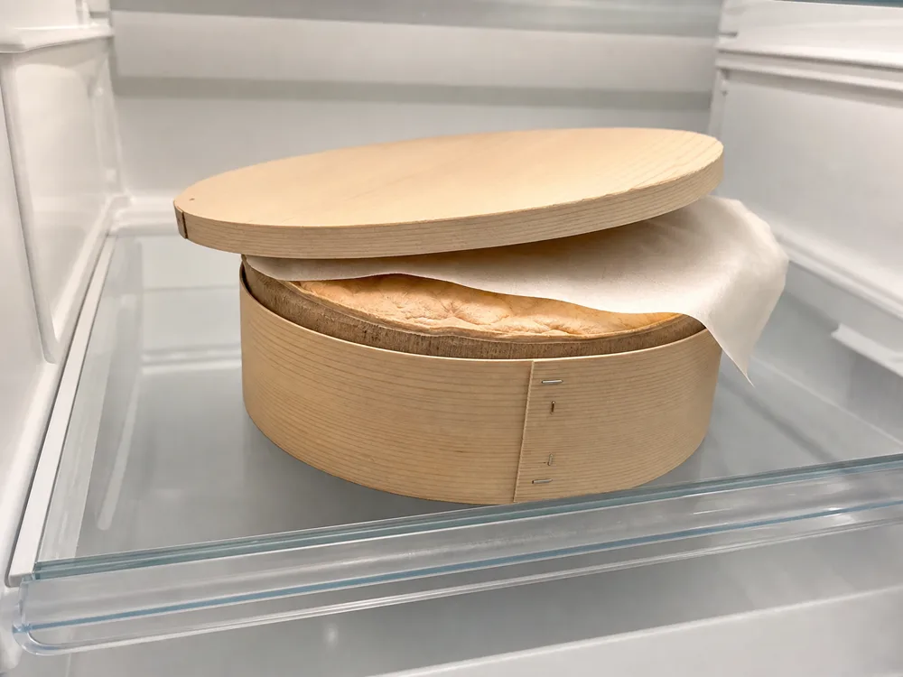 Vacherin Mont d'Or stored level in its spruce box with breathable paper - Vacherin Mont d'Or | KnowTheCheese