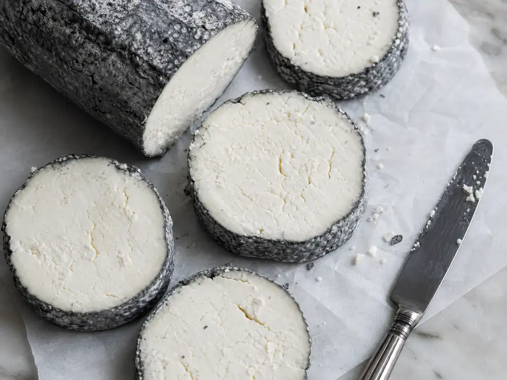 Ash coated goat cheese slices with dense crumbly white paste - Yarra Valley Vintage Savourine | KnowTheCheese